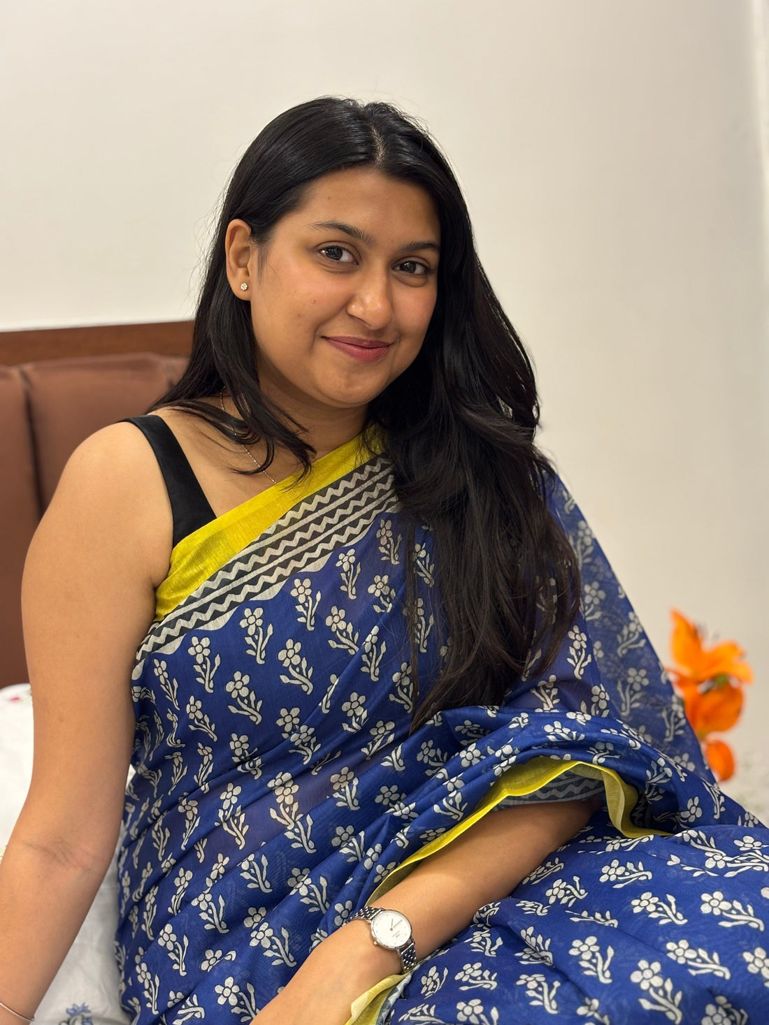 Woman walking confidently in a well-draped saree