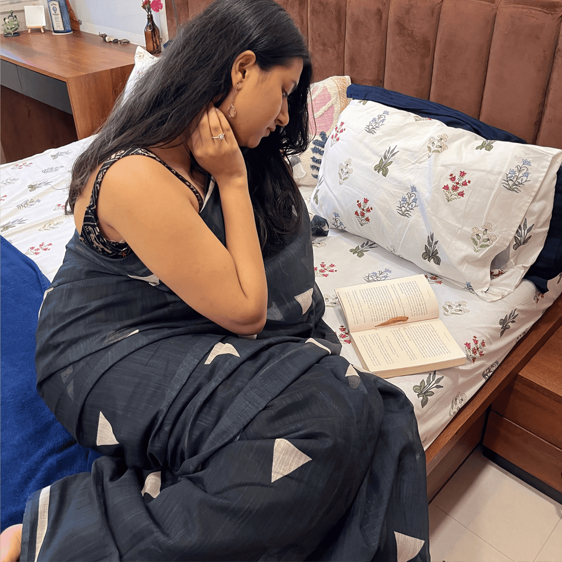 Woman wearing a linen saree with a clean, structured drape